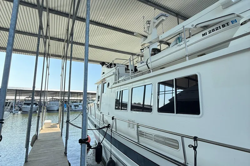 Slide: The Image of 2007 Nordic Tug 54 docked in a covered marina, side view. - 21