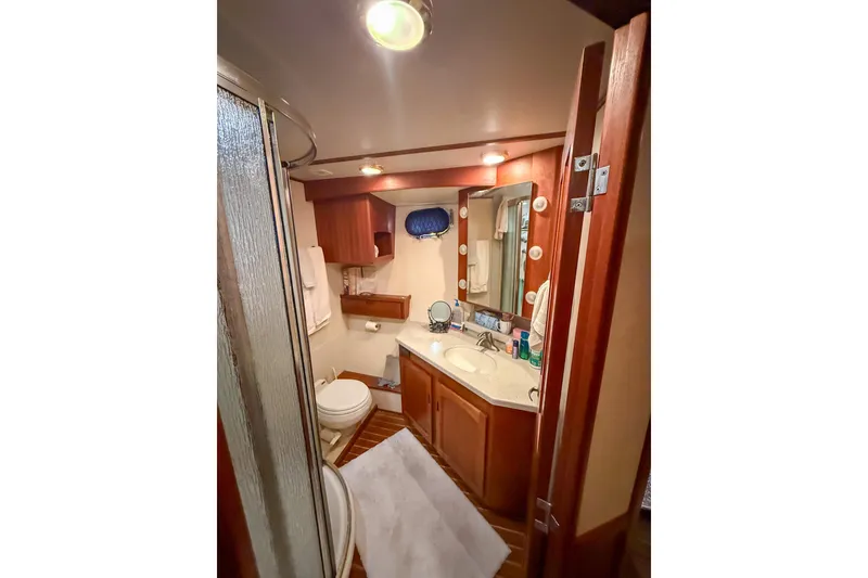 Slide: The Image of Luxurious bathroom in 2007 Nordic Tug 54 yacht with wood accents and modern amenities. - 38