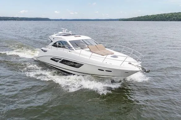 Slide: The Image of 2016 Sea Ray Sundancer 510 cruising on a serene lake under a clear sky. - 10