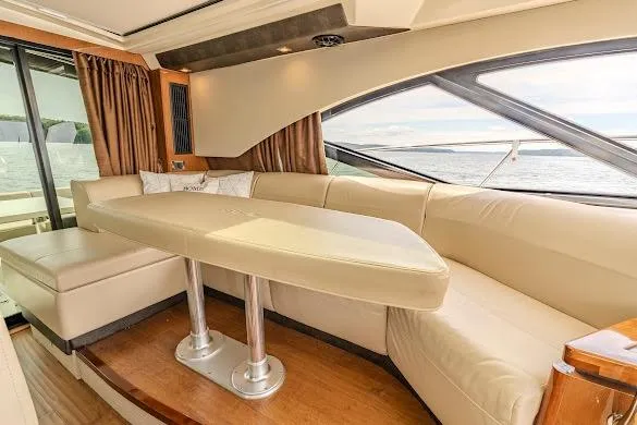 Slide: The Image of Luxurious interior of 2016 Sea Ray Sundancer 510 yacht with elegant seating and scenic window view. - 24