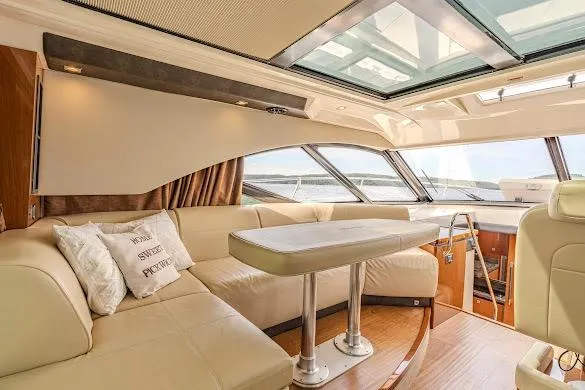 Slide: The Image of Luxurious interior of 2016 Sea Ray Sundancer 510 yacht with plush seating and panoramic windows. - 29