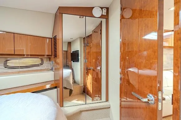 Slide: The Image of Luxurious interior of 2016 Sea Ray Sundancer 510 yacht with wood finishes and mirrored closet. - 39