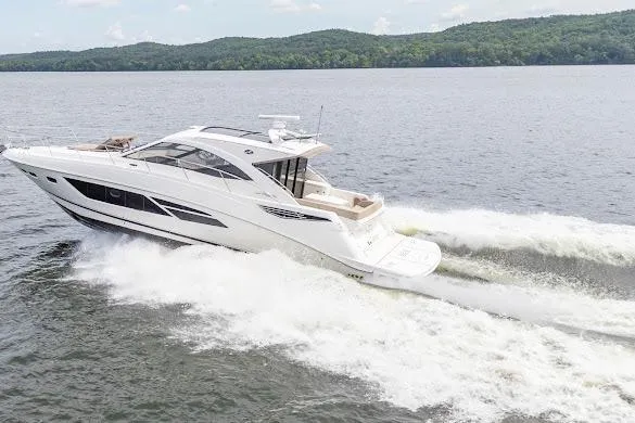 Slide: The Image of 2016 Sea Ray Sundancer 510 cruising on a lake with scenic forested hills. - 4
