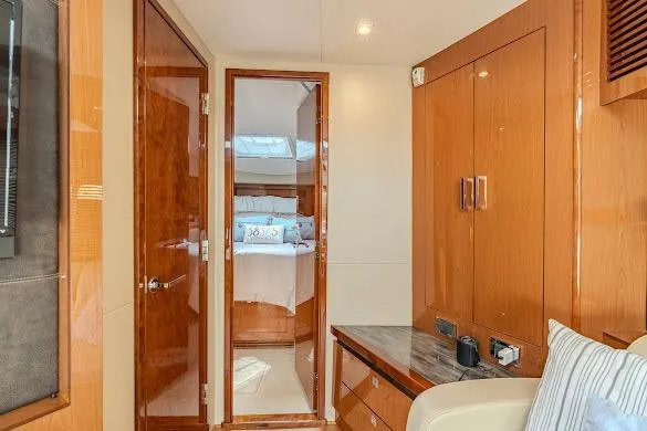 Slide: The Image of Luxurious interior of 2016 Sea Ray Sundancer 510 yacht with wooden cabinetry and cozy bedroom. - 43
