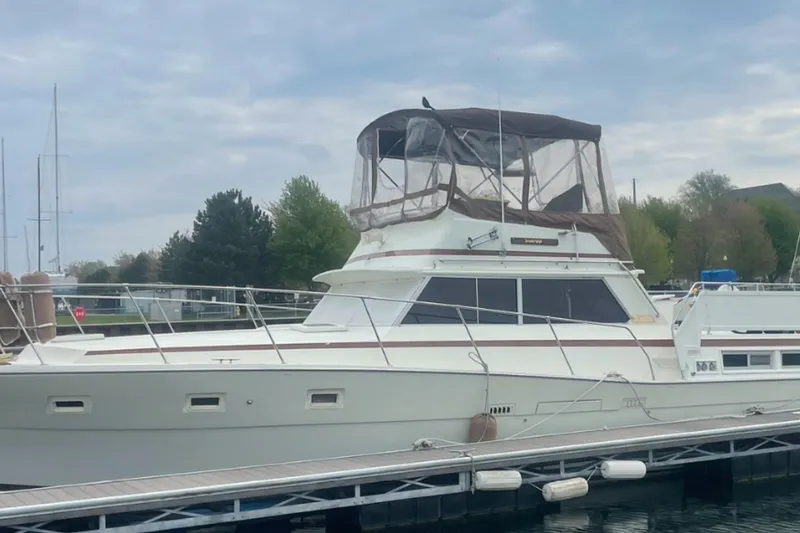 The Image of 1979 Viking 43 Double Cabin yacht docked at a marina under cloudy skies. - 0