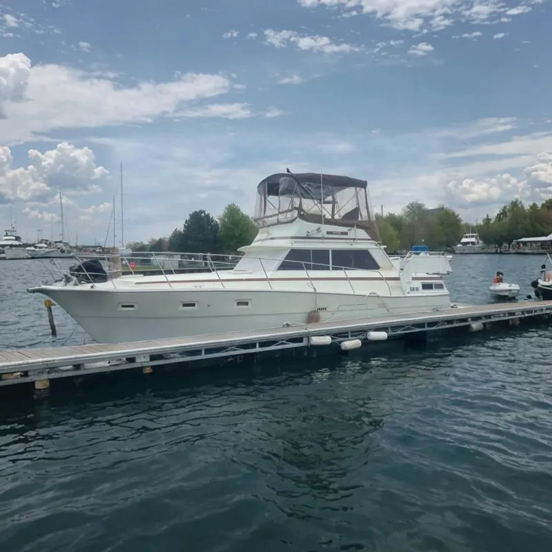 The Image of 1979 Viking 43 Double Cabin yacht docked at a marina under cloudy skies. - 0