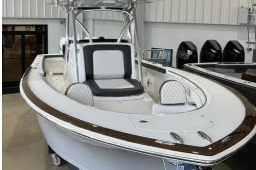 Slide: The Image of A 2022 Valhalla Boatworks V-33 in a showroom. It features a sleek design with cushioned seating. - 1
