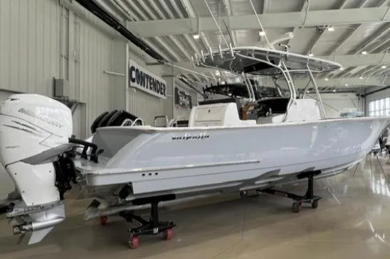 Slide: The Image of 2022 Valhalla Boatworks V-33 in showroom, featuring sleek design and powerful outboard engine. - 2