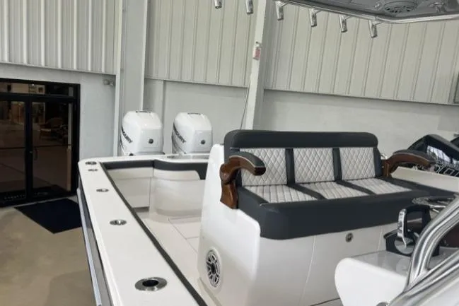 Slide: The Image of 2022 Valhalla Boatworks V-33 interior with seating and dual engines in a showroom. - 12