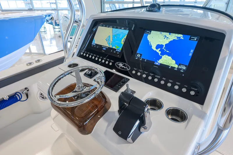 Slide: The Image of 2023 Valhalla Boatworks V-33 helm with dual navigation screens and steering wheel. - 26