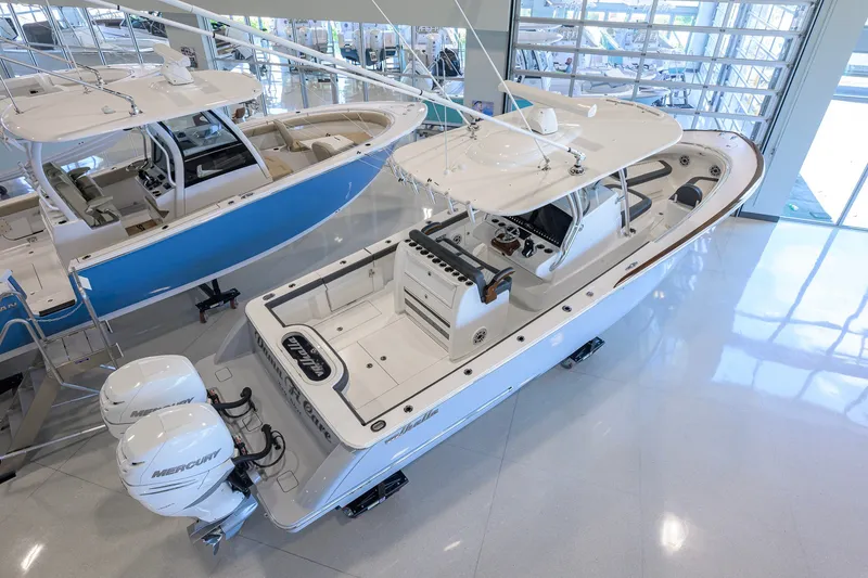 Slide: The Image of 2023 Valhalla Boatworks V-33 in showroom, featuring dual Mercury engines. - 7