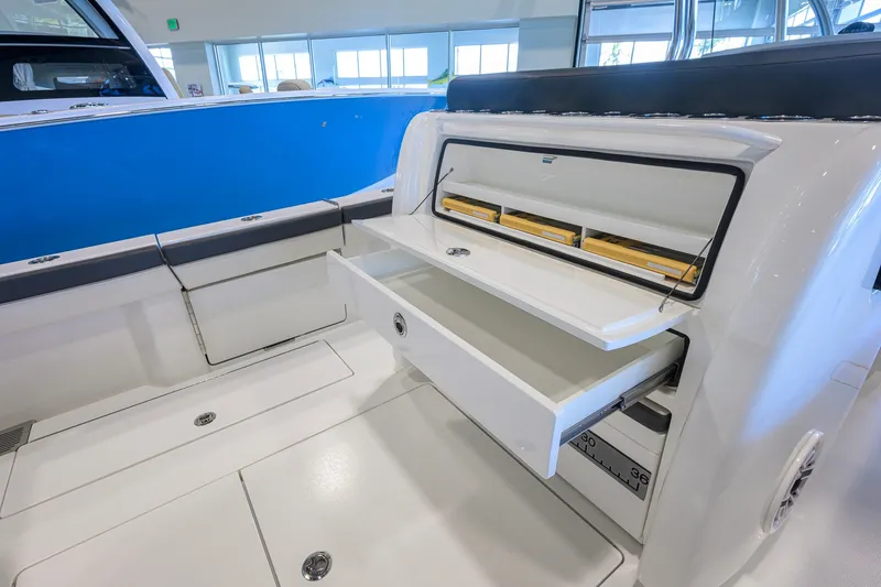 Slide: The Image of 2023 Valhalla Boatworks V-33 interior with open storage compartments and sleek design. - 34