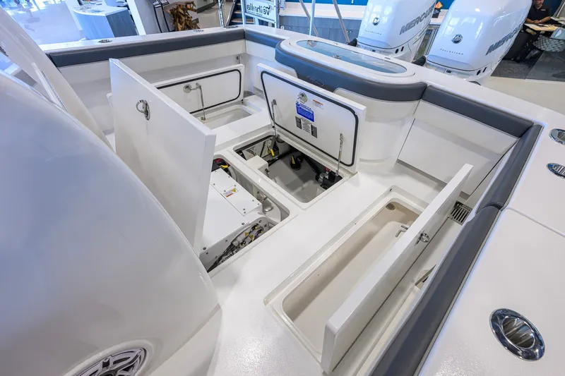 Slide: The Image of 2023 Valhalla Boatworks V-33 interior with open storage compartments and visible engine components. - 47