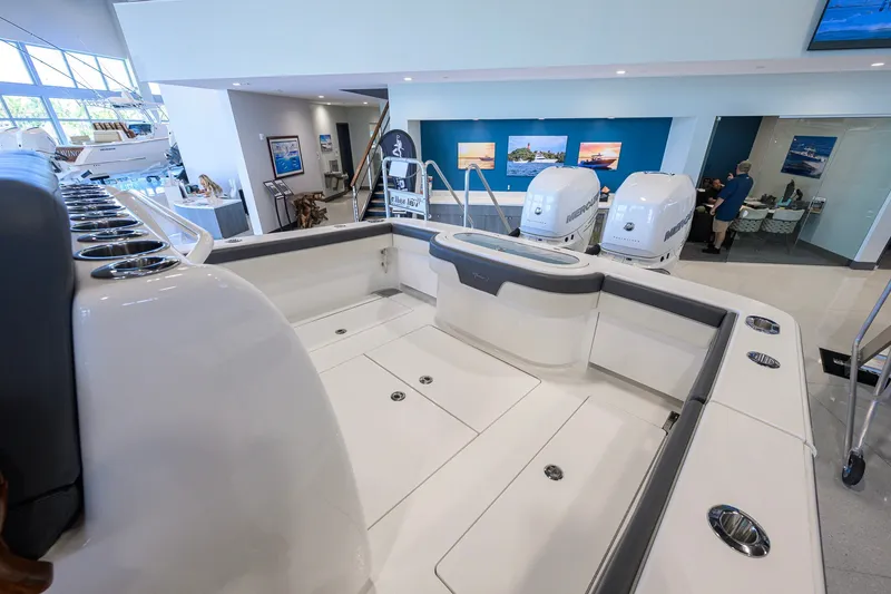 Slide: The Image of 2023 Valhalla Boatworks V-33 interior with dual Mercury engines in showroom. - 31