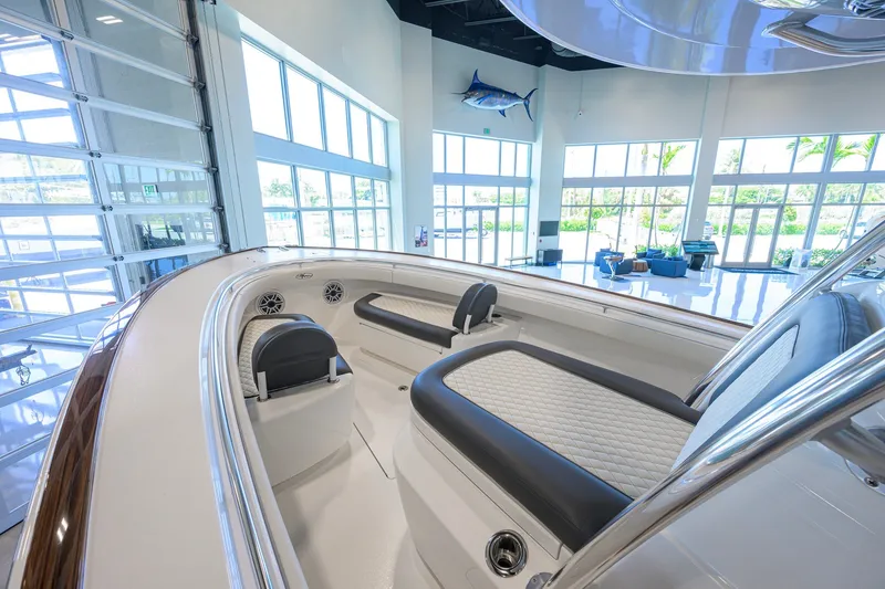 Slide: The Image of 2023 Valhalla Boatworks V-33 interior in showroom, featuring sleek seating and modern design. - 14