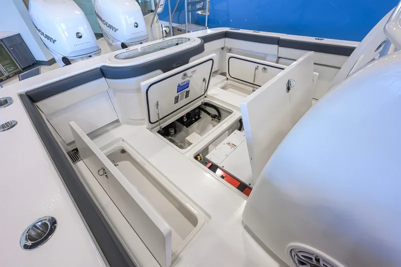 Slide: The Image of 2023 Valhalla Boatworks V-33 interior with open storage compartments and Mercury engines. - 46