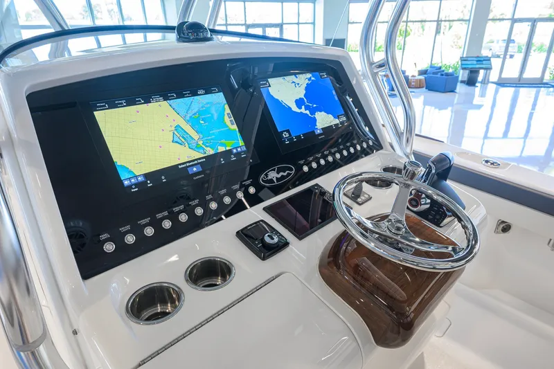 Slide: The Image of 2023 Valhalla Boatworks V-33 helm with dual navigation screens and modern controls. - 9