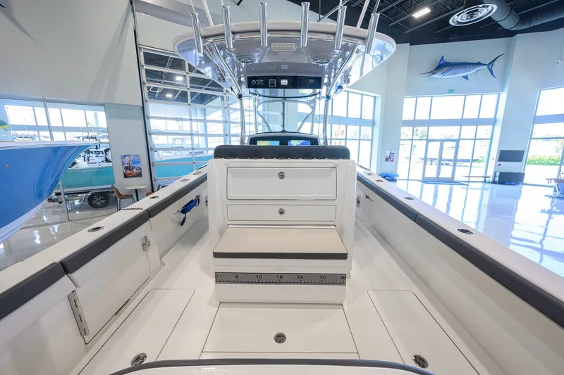 Slide: The Image of 2023 Valhalla Boatworks V-33 interior, showcasing seating and storage in a showroom setting. - 37