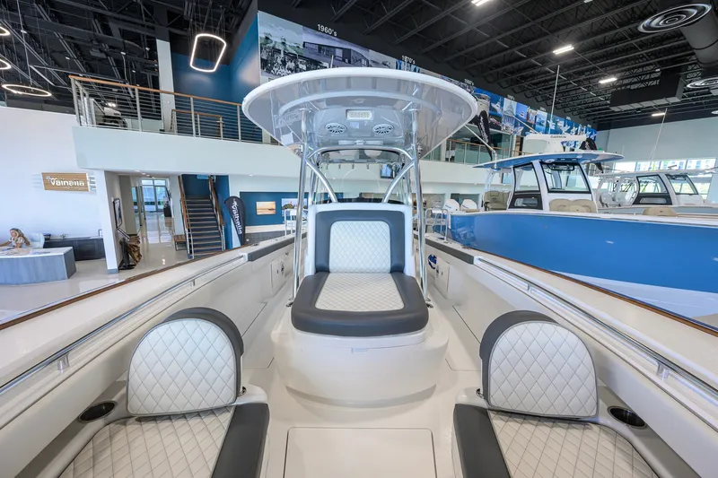 Slide: The Image of 2023 Valhalla Boatworks V-33 interior in showroom, featuring luxurious seating and modern design. - 21