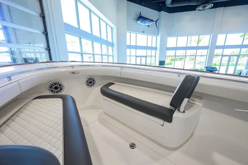 Slide: The Image of 2023 Valhalla Boatworks V-33 interior with cushioned seating and modern design in showroom. - 15