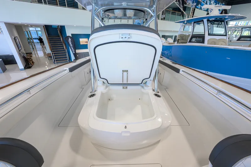 Slide: The Image of 2023 Valhalla Boatworks V-33 interior with open storage compartment in showroom. - 22