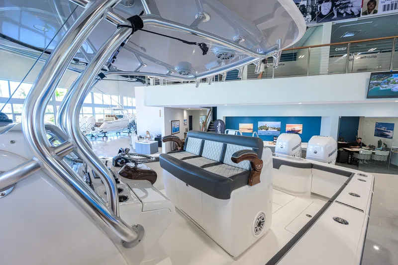 Slide: The Image of 2023 Valhalla Boatworks V-33 interior showcasing luxury seating and modern design in showroom. - 12