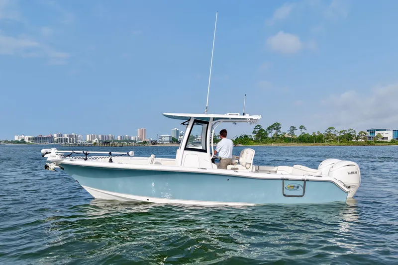 Slide: The Image of 2026 Sea Hunt Ultra 265 SE boat cruising on a calm waterway. - 0