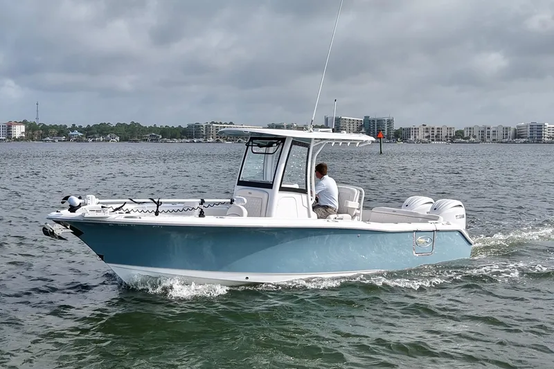 Slide: The Image of 2026 Sea Hunt Ultra 265 SE boat cruising on a calm waterway. - 1