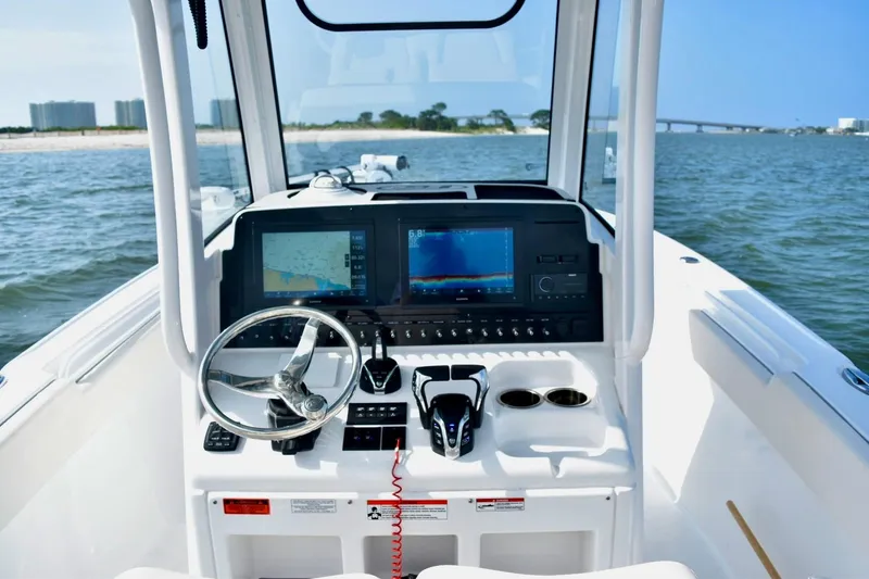 Slide: The Image of Cockpit view of 2026 Sea Hunt Ultra 265 SE boat with advanced navigation system. - 10