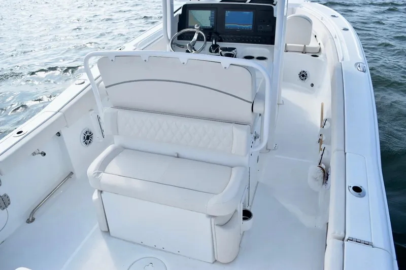 Slide: The Image of 2026 Sea Hunt Ultra 265 SE boat interior with white seating and modern dashboard. - 12