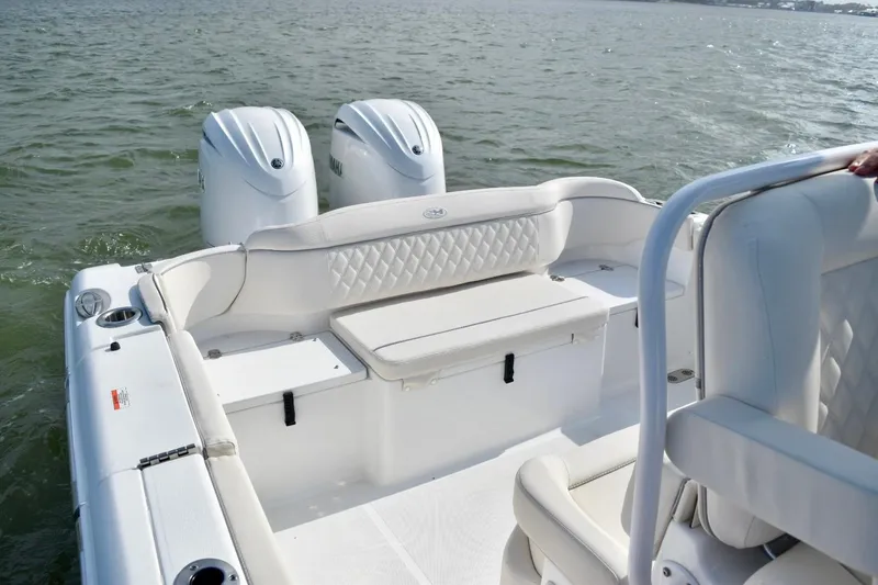 Slide: The Image of 2026 Sea Hunt Ultra 265 SE boat with dual engines on open water. - 13