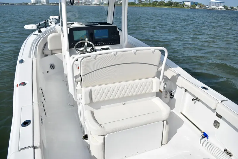 Slide: The Image of 2026 Sea Hunt Ultra 265 SE boat interior with white seating and steering console. - 14