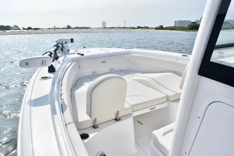 Slide: The Image of 2026 Sea Hunt Ultra 265 SE boat with spacious seating on calm waters. - 15