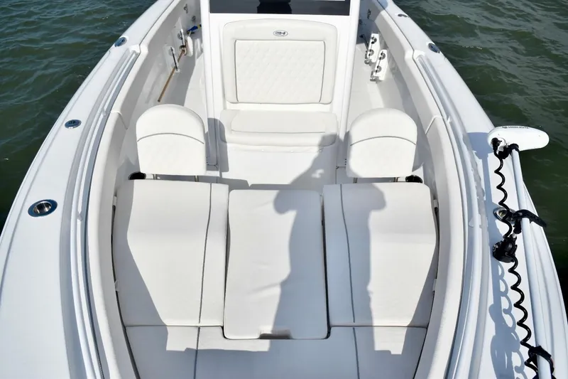 Slide: The Image of 2026 Sea Hunt Ultra 265 SE boat interior with white cushioned seating. - 16
