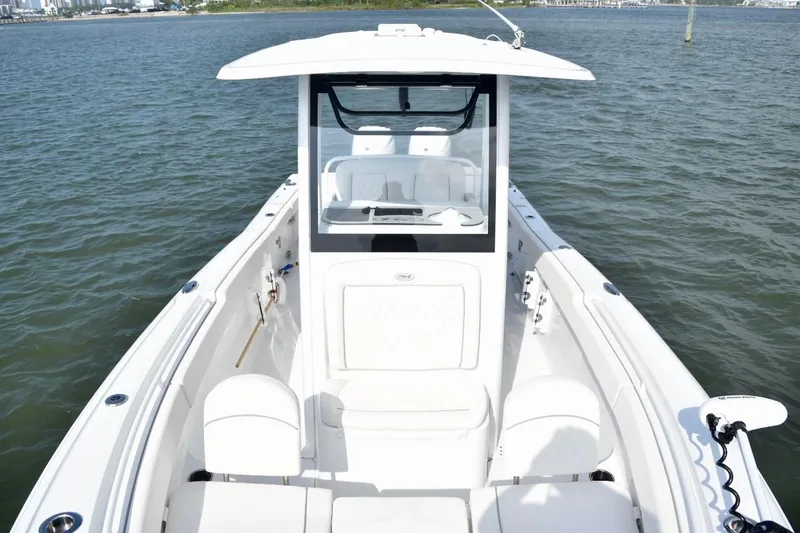 Slide: The Image of 2026 Sea Hunt Ultra 265 SE boat on water, showcasing sleek design and spacious deck. - 17