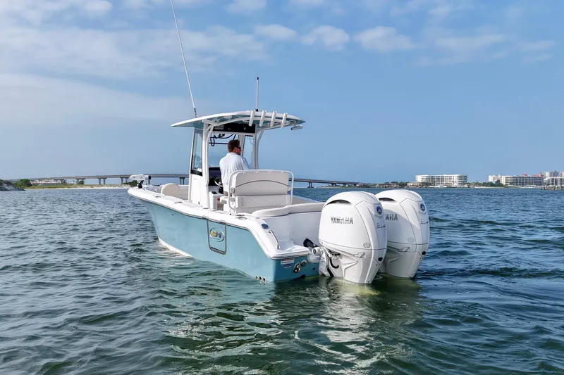 Slide: The Image of 2026 Sea Hunt Ultra 265 SE boat with dual Yamaha engines on open water. - 3