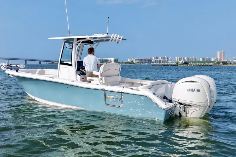 Slide: The Image of 2026 Sea Hunt Ultra 265 SE boat on water, featuring Yamaha engine, cityscape background. - 5