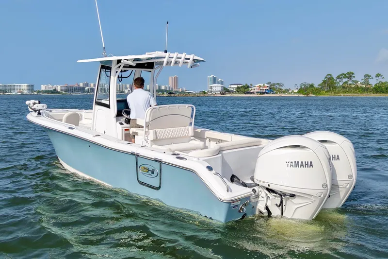 Slide: The Image of 2026 Sea Hunt Ultra 265 SE boat cruising on water with dual Yamaha engines. - 7