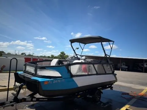 Slide: The Image of A 2023 Sea-Doo 21 Switch Cruise on a trailer, featuring a blue and white hull. - 2