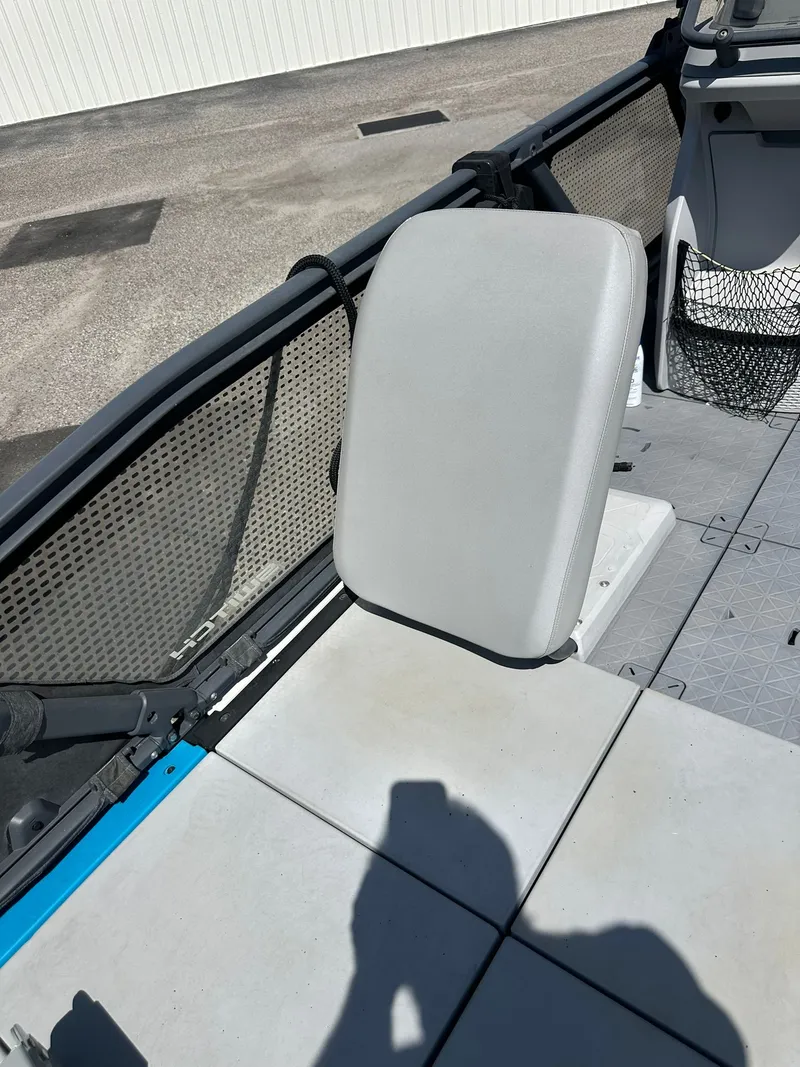 Slide: The Image of A seat on a 2023 Sea-Doo 21 SWITCH SPORT, featuring gray upholstery and a mesh storage pocket. - 14