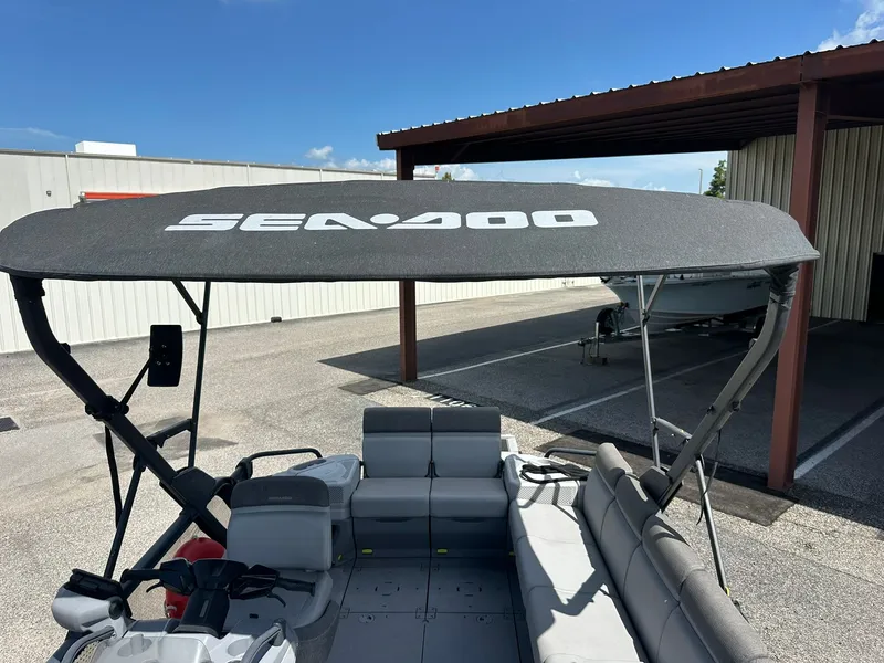 Slide: The Image of The image shows the deck of a Sea-Doo 21 SWITCH SPORT boat with a sunshade. - 19