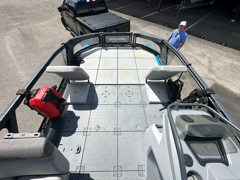 Slide: The Image of The image shows the deck of a 2023 Sea-Doo 21 SWITCH SPORT with seating and a helm console. - 24