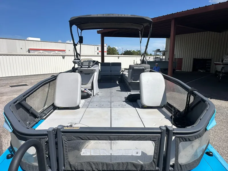 Slide: The Image of Sea-Doo 21 SWITCH SPORT 2023 with spacious deck and seating, parked in a covered area. - 29