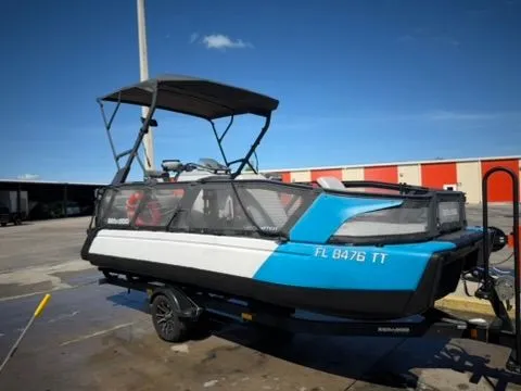 Slide: The Image of A 2023 Sea-Doo 21 Switch Cruise on a trailer, featuring a blue and white hull, under clear skies. - 3