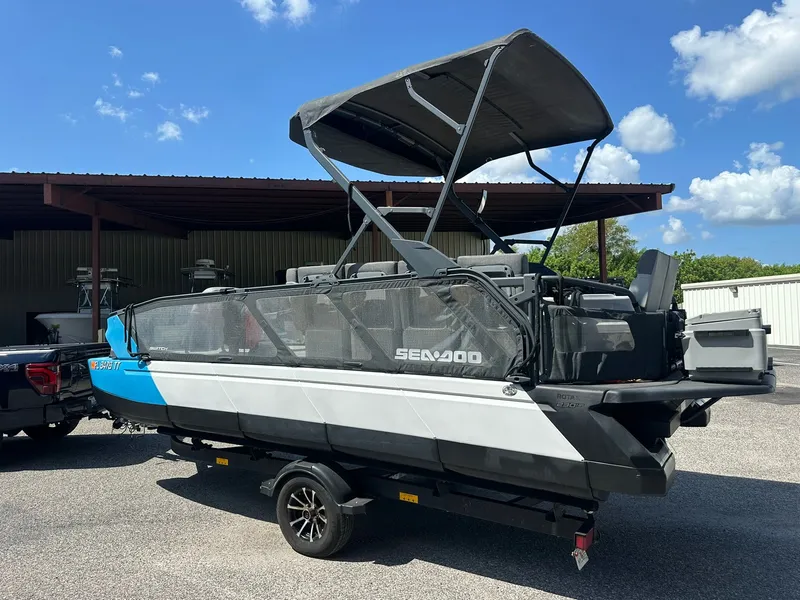 Slide: The Image of A 2023 Sea-Doo 21 SWITCH SPORT on a trailer, featuring a black canopy and blue accents. - 5