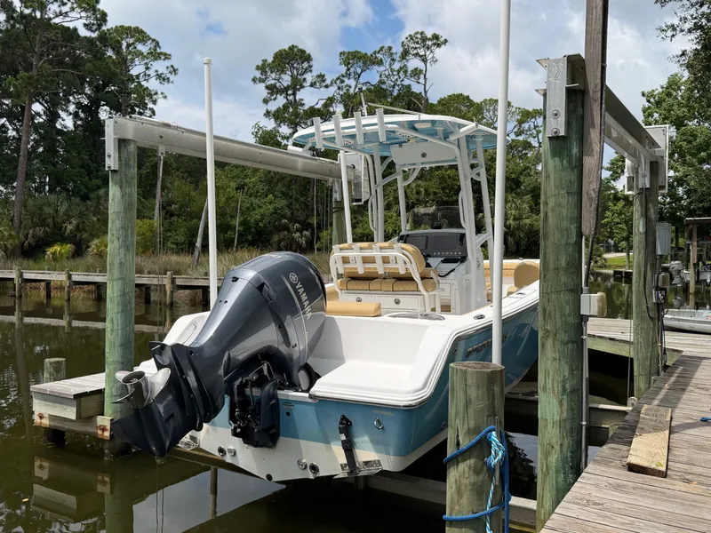 Slide: The Image of A 2021 Sportsman Heritage 211 Center Console boat docked at a wooden pier. - 15