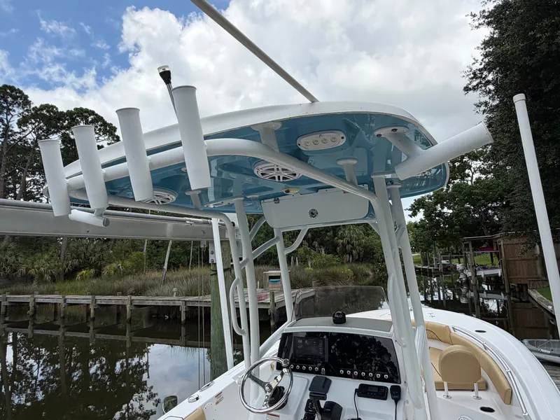 Slide: The Image of The image shows the helm of a 2021 Sportsman Heritage 211 Center Console boat. - 16