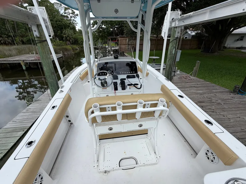 Slide: The Image of The image shows a 2021 Sportsman Heritage 211 Center Console boat at a dock. - 20