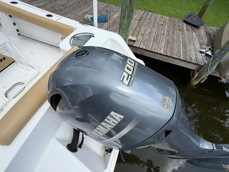 Slide: The Image of A Yamaha 200 outboard motor on a Sportsman Heritage 211 Center Console boat, next to a wooden dock. - 22