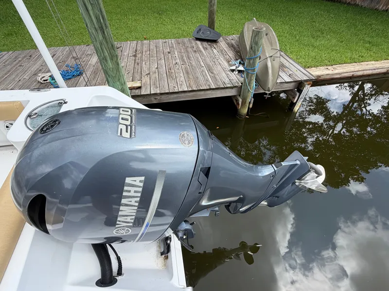 Slide: The Image of A Yamaha outboard motor on a boat docked at a wooden pier. - 23